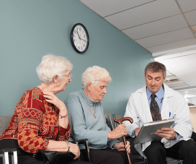 Example of a doctor reviewing plans with patient and patient's companion at a low vision clinic